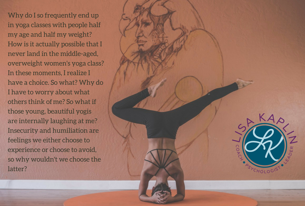 Woman in inverted yoga pose with her back to the camera against a peach background