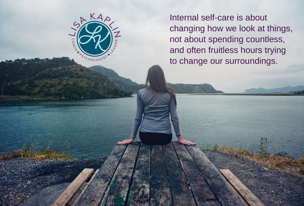 A color photo of a white woman with long brown hair taken from behind. She is sitting on a dock looking out at the water. The text in the top right corner of the photo reads “Internal self-care is about changing how we look at things, not about spending countless, and often fruitless hours trying to change our surroundings.” The Lisa Kaplin logo is in the top left corner of the image.